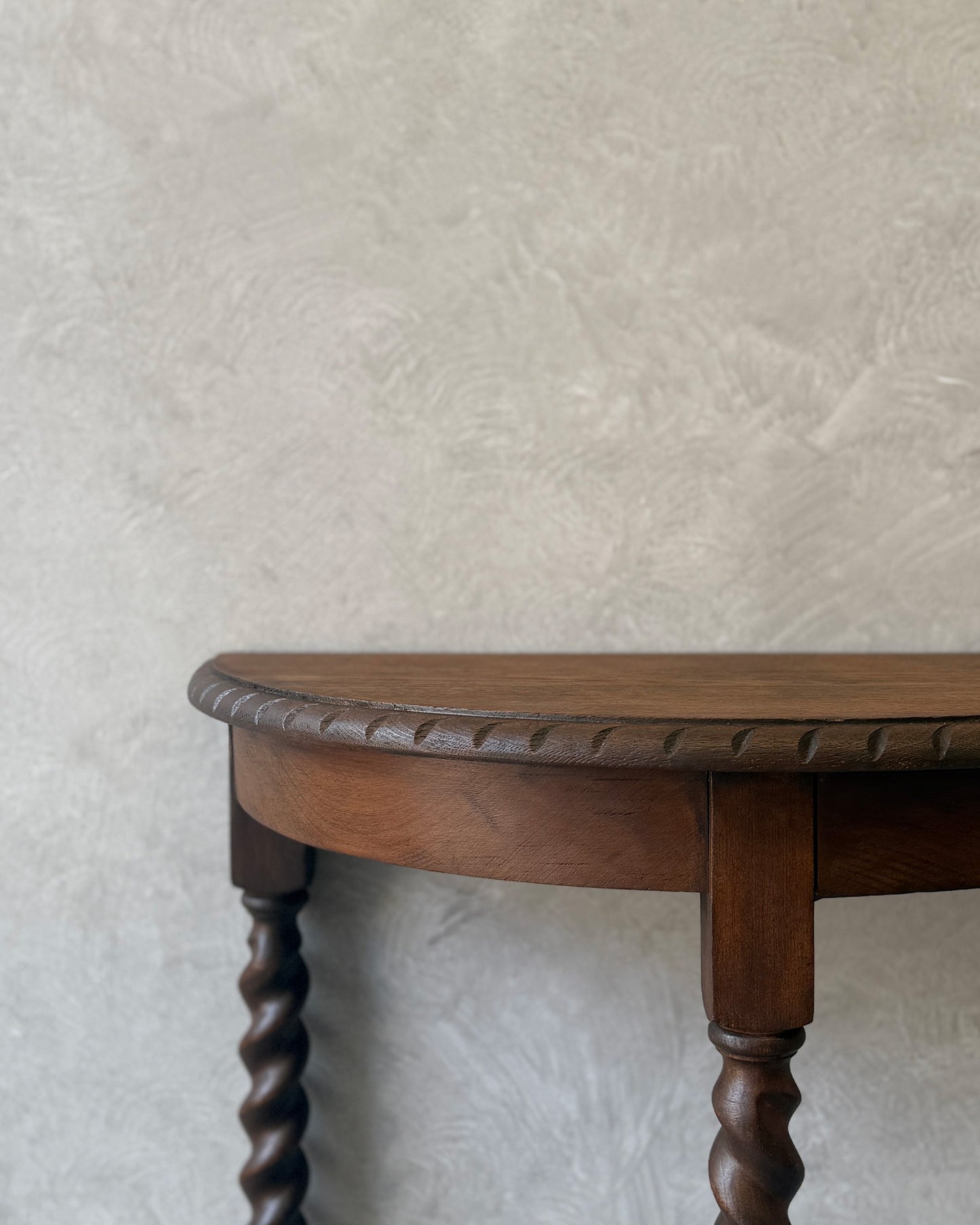 Demi-lune console table with barley twist legs in dark wood, restored in Sydney workshop