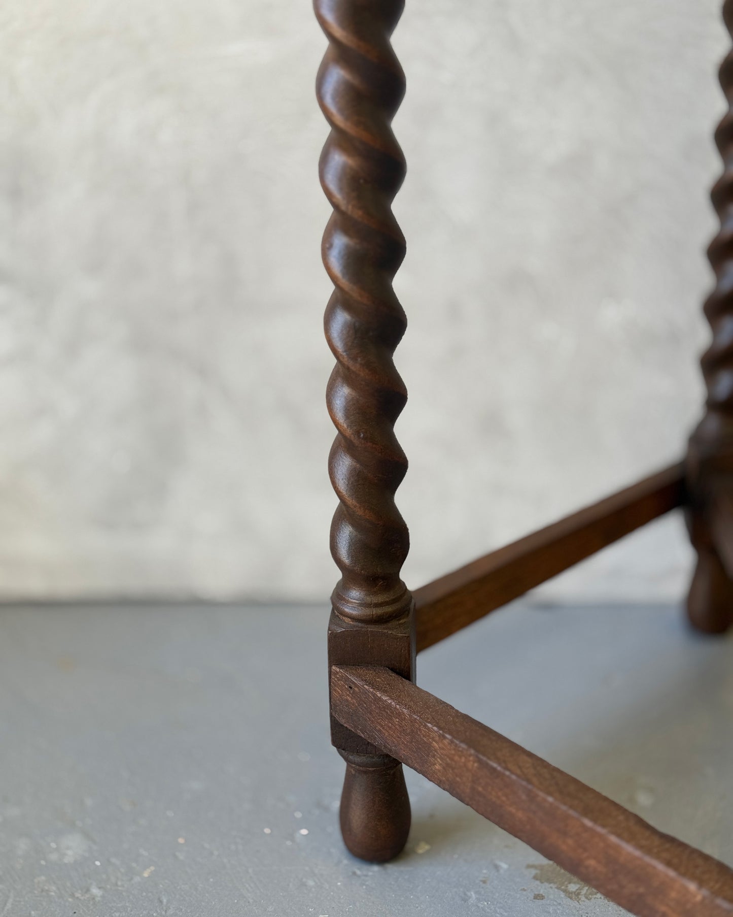 Demi-lune console table with barley twist legs in dark wood, restored in Sydney workshop