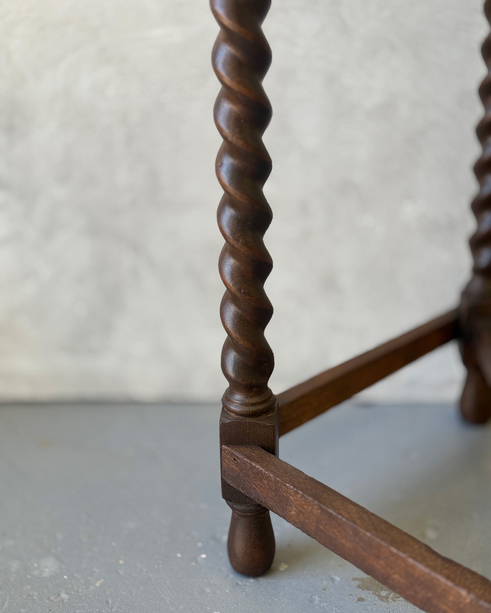 Demi-lune console table with barley twist legs in dark wood, restored in Sydney workshop
