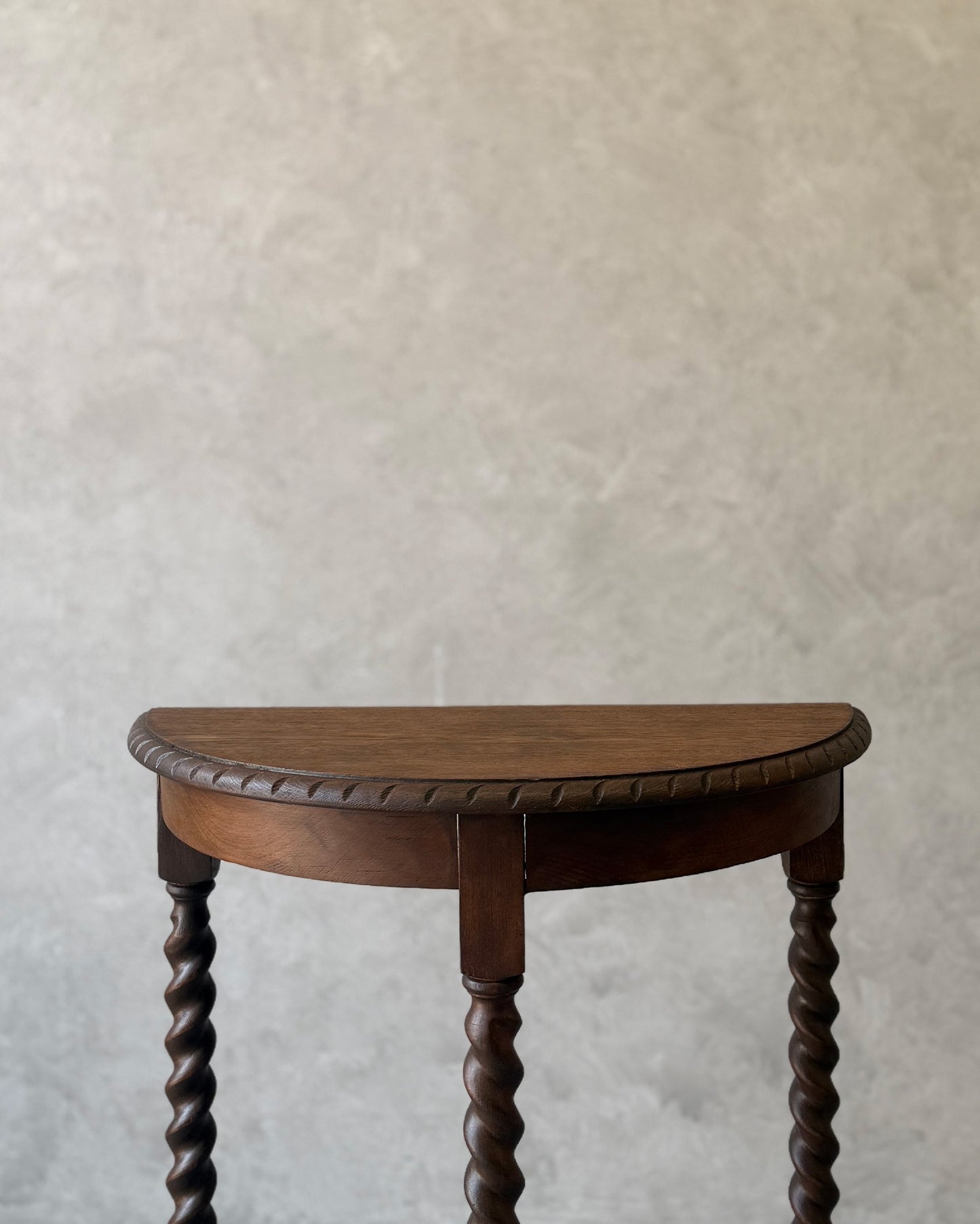 Demi-lune console table with barley twist legs in dark wood, restored in Sydney workshop