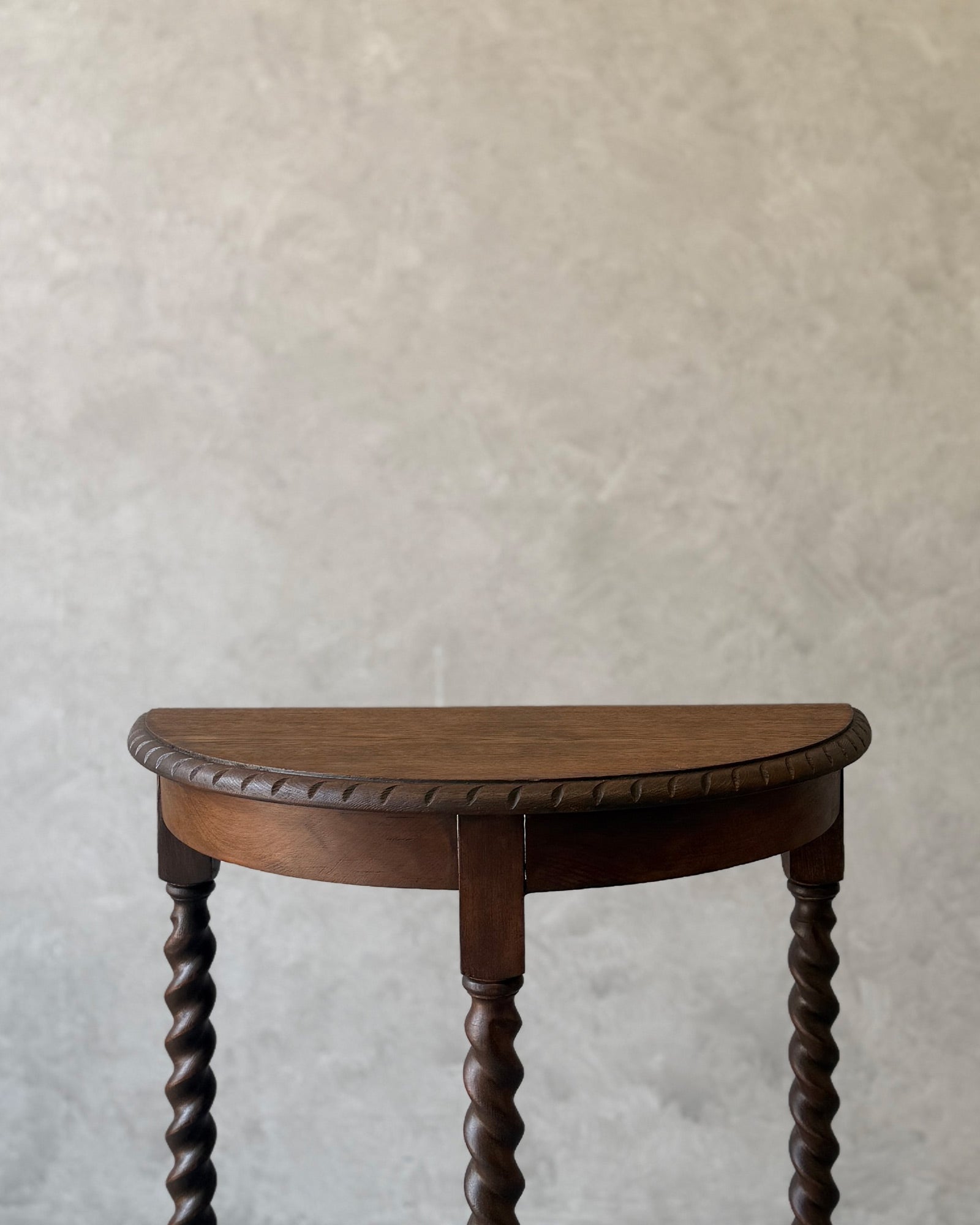Demi-lune console table with barley twist legs in dark wood, restored in Sydney workshop