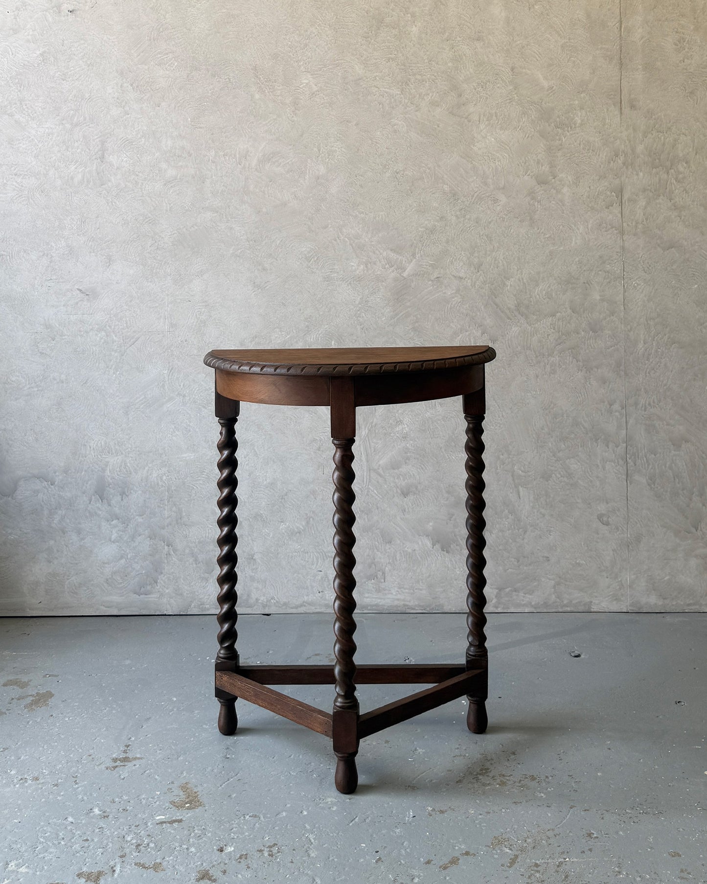 Demi-lune console table with barley twist legs in dark wood, restored in Sydney workshop