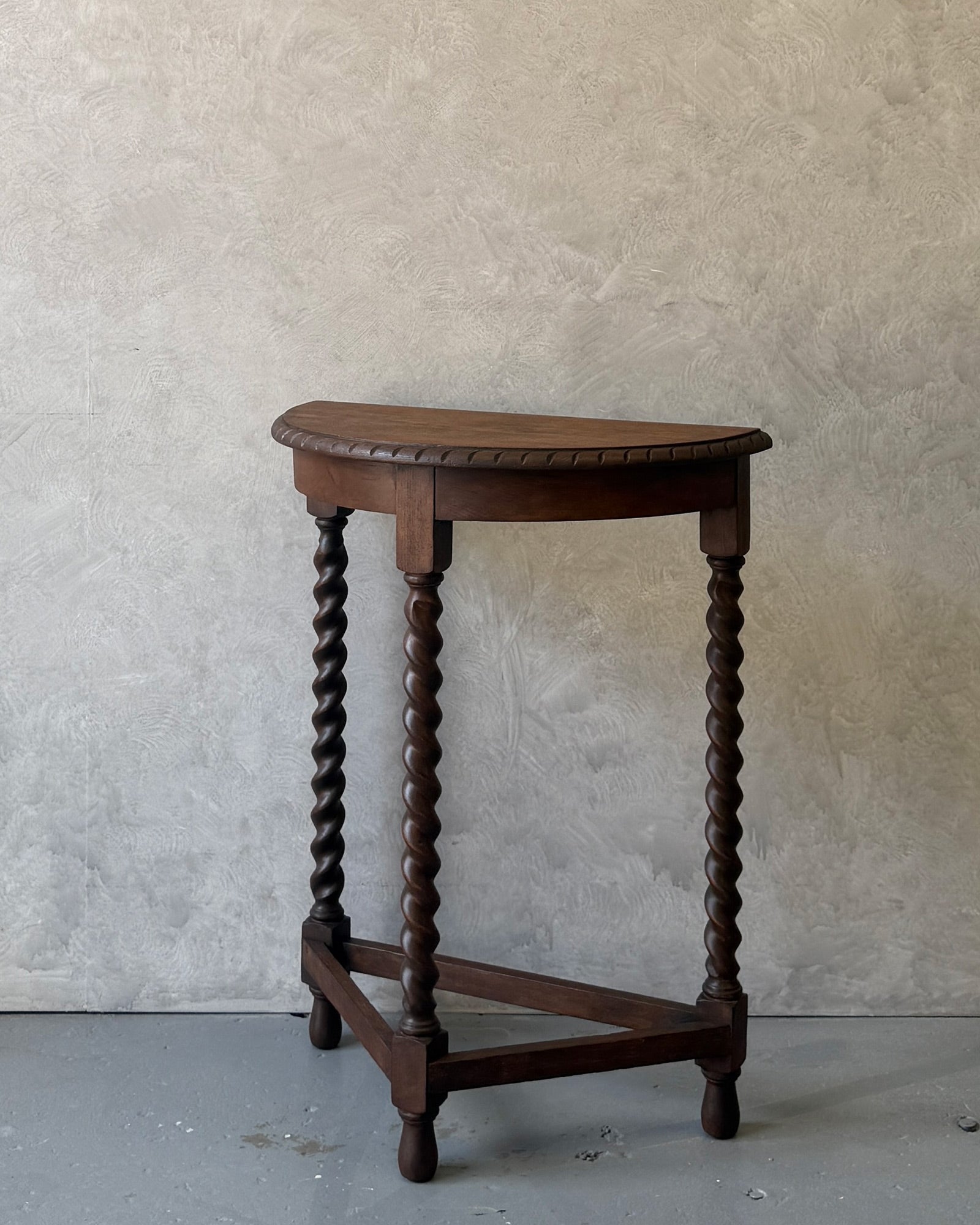 Demi-lune console table with barley twist legs in dark wood, restored in Sydney workshop